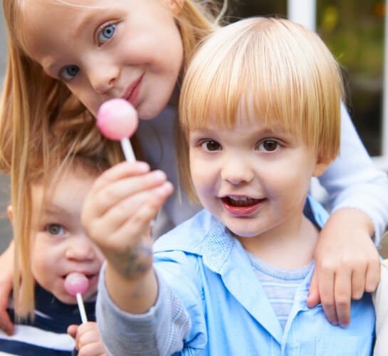 Children enjoying lollipops