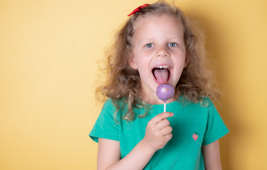 Elementary student enjoying lollipop