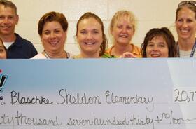 Blaschke Sheldon Elementary School fundraising team holding check