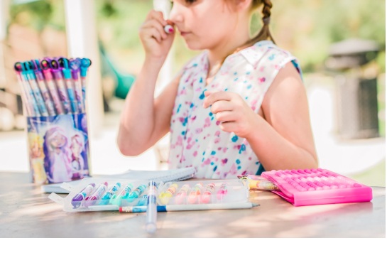 Elementary school student smelling smarkers