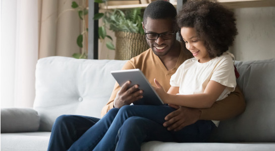 Dad and daughter on tablet