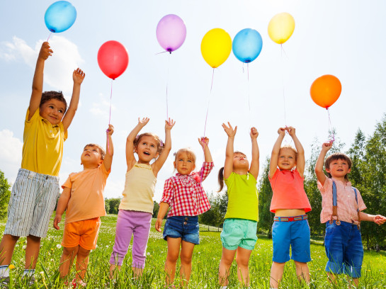 Elementary School Students Holding Balloons