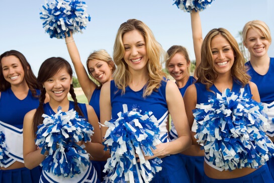 High school cheerleaders holding pom poms