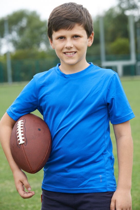 Middle School student holding football