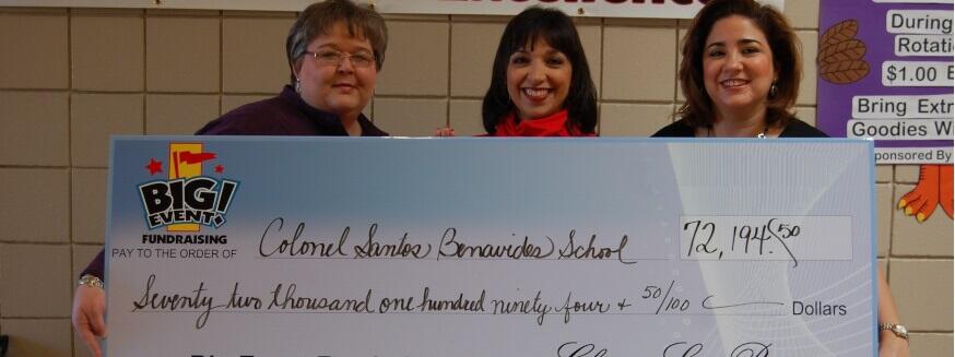 Santos Benavides School fundraising team holding check