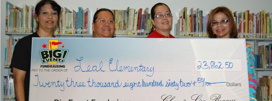 Leal Elementary School fundraising team holding check