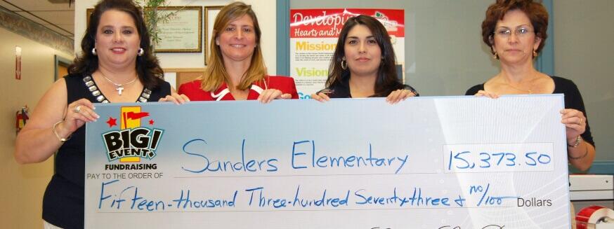 Sanders Elementary School fundraising team holding check