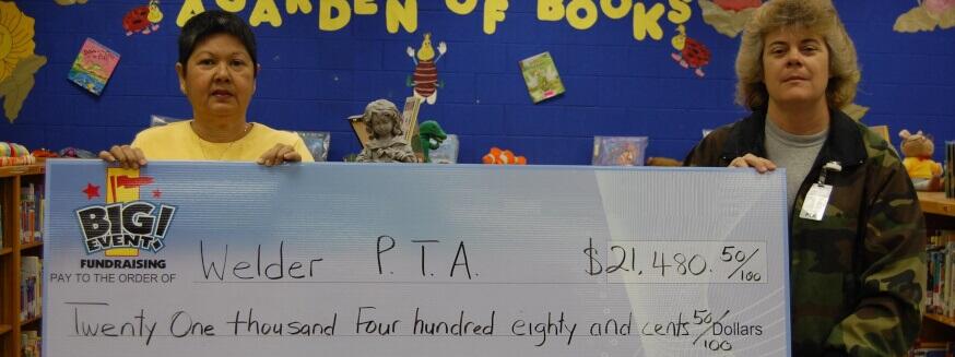 Welder Elementary School PTA fundraising team holding check