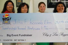 John F. Kennedy Elementary fundraising team holding check
