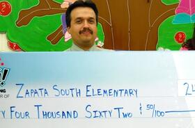 Zapata South Elementary School fundraising team holding check