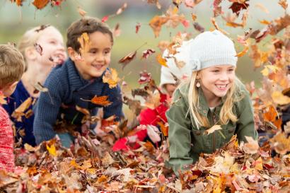 Children playing in the fall leaves