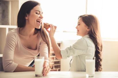 Girl feeding muffin to mom